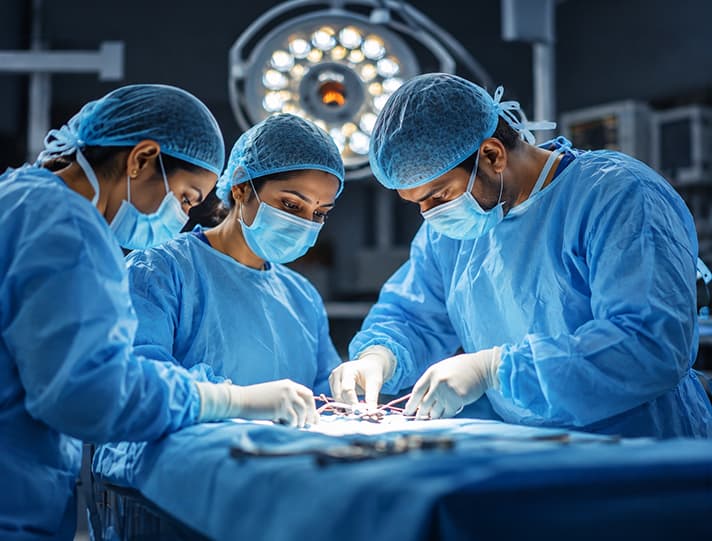 Surgical team operating under theatre lights